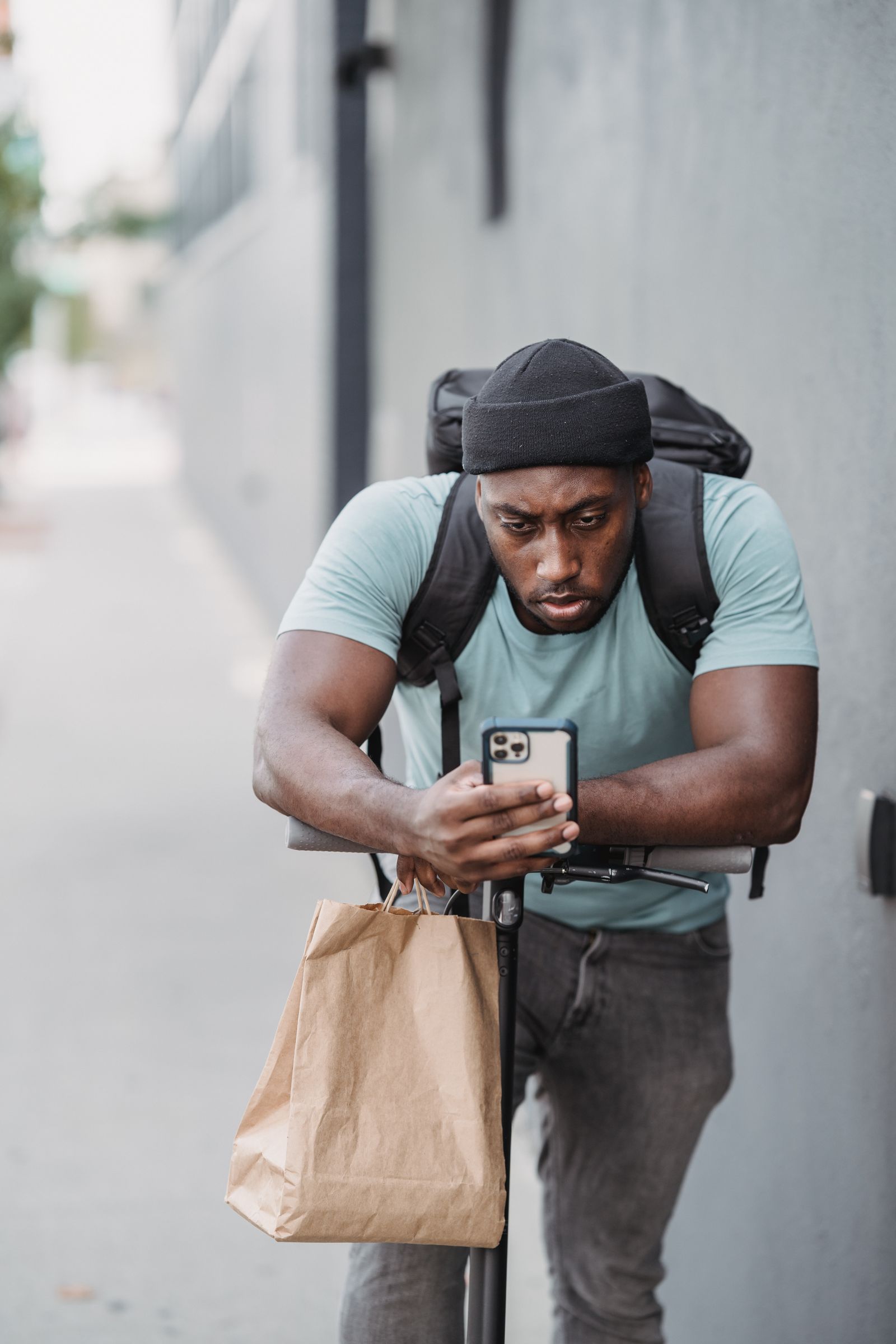 A delivery professional reviewing his route on a phone