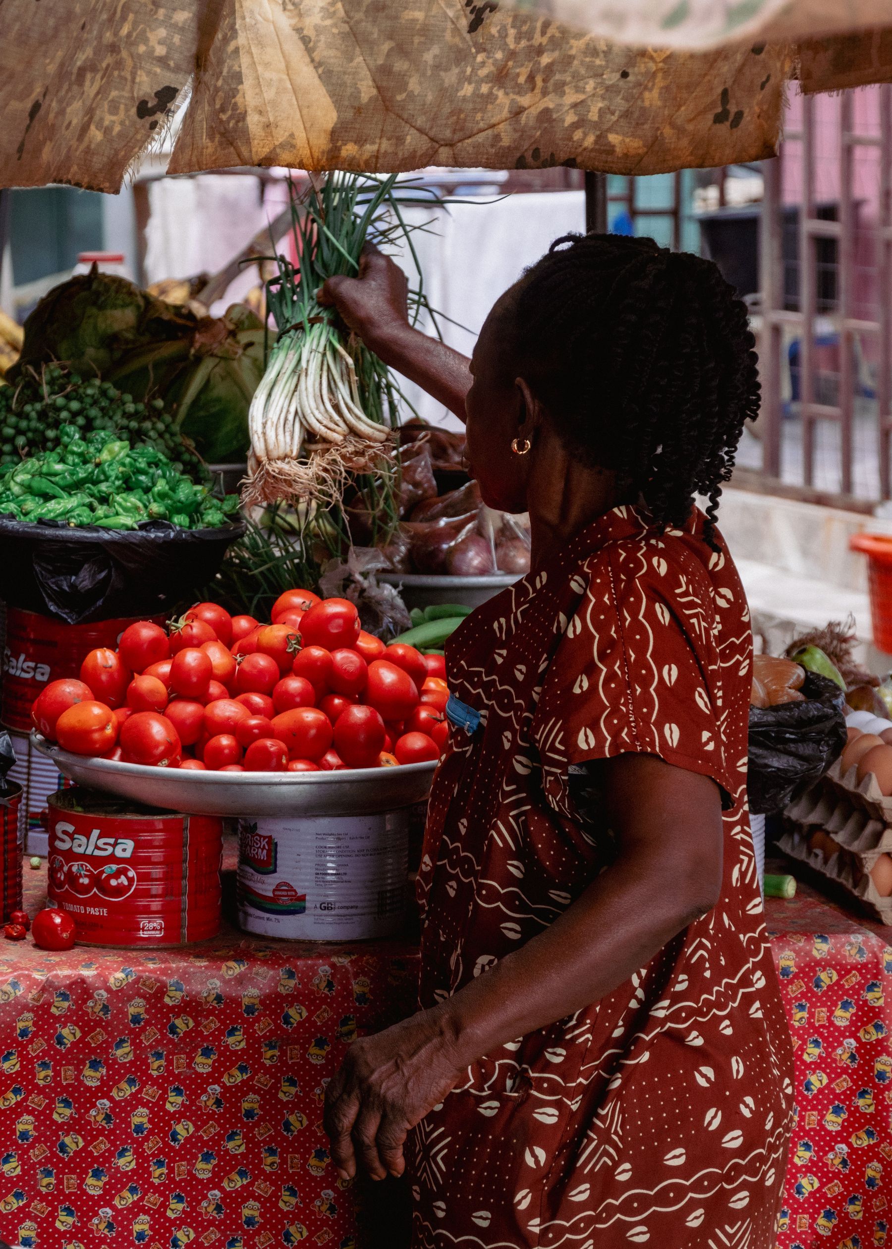 A shopper selecting fresh produce at a market in Ghana